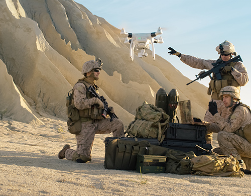 Soldiers use a drone for scouting during a military operation in the desert.