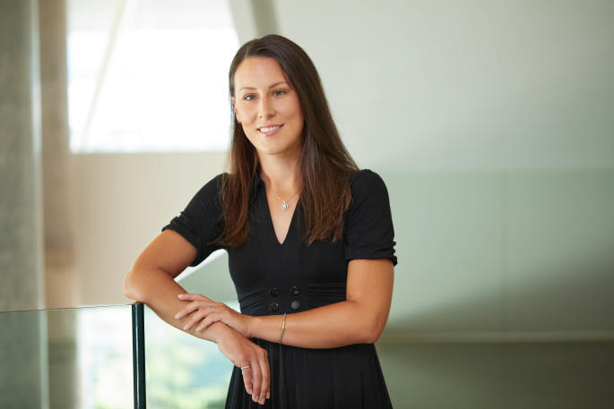 Confident professional at a technology institute, representing innovation and expertise.