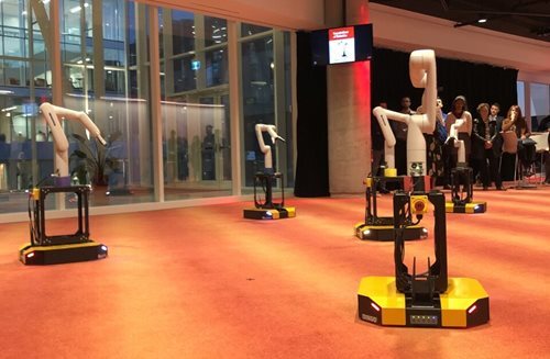 Robotic arms on display at a tech university showcasing automation technology.