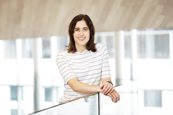 Confident professional at a tech university's modern campus.