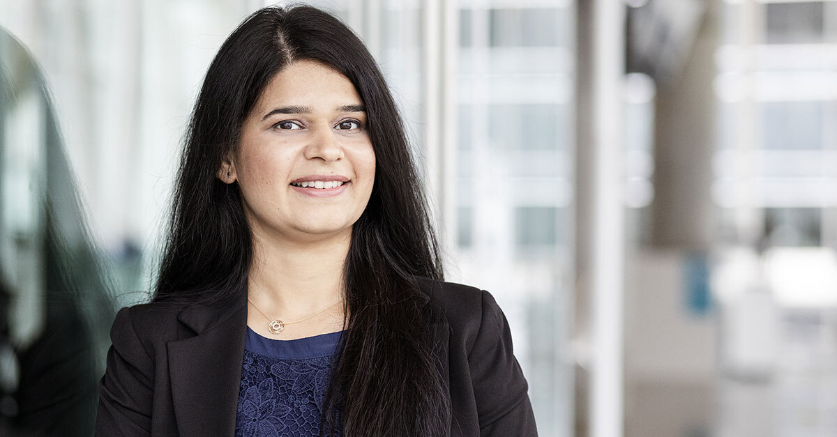 Confident tech university professional in modern corporate setting.