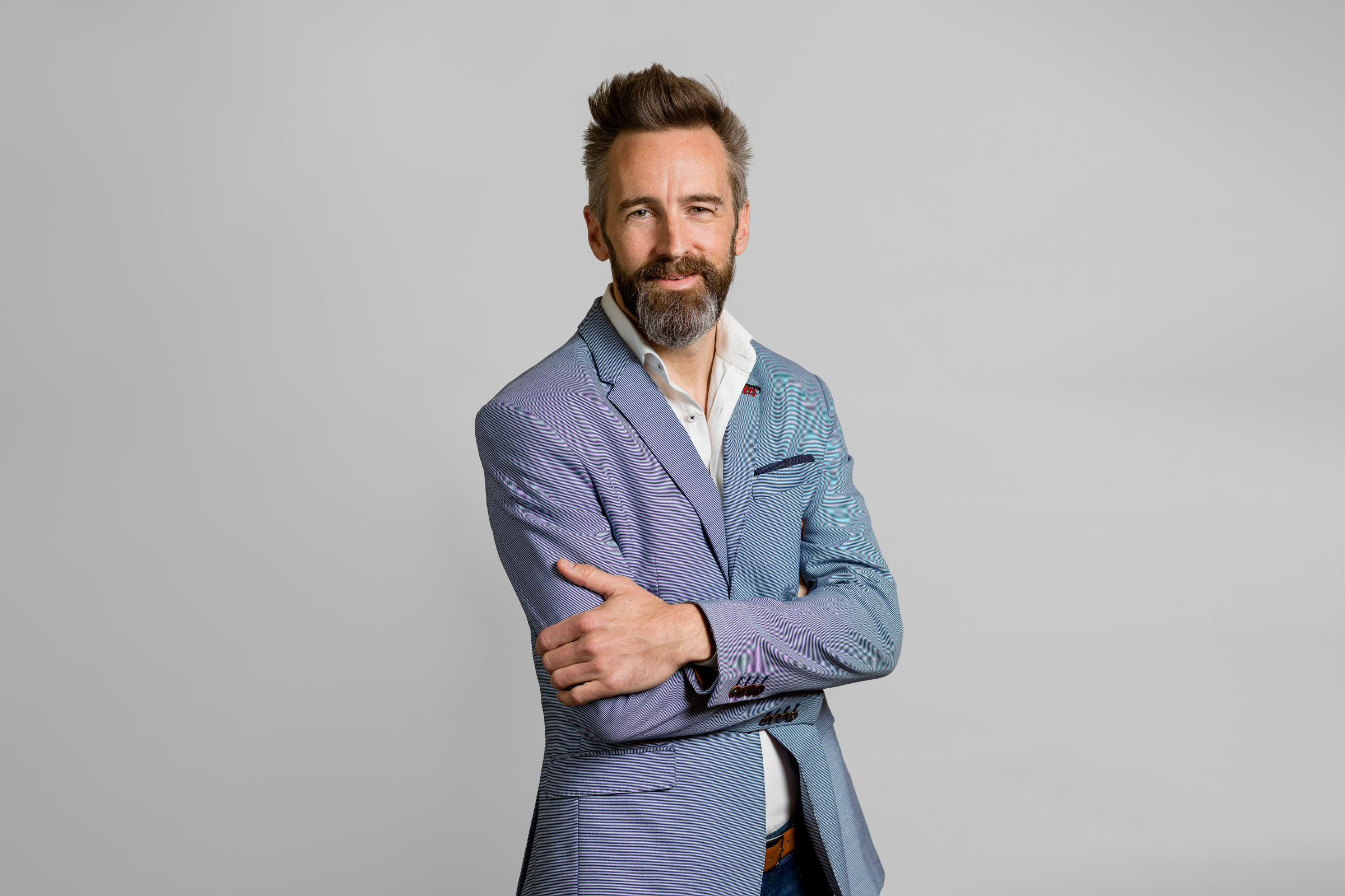 Confident professional in a light blue suit embodies innovation and expertise.