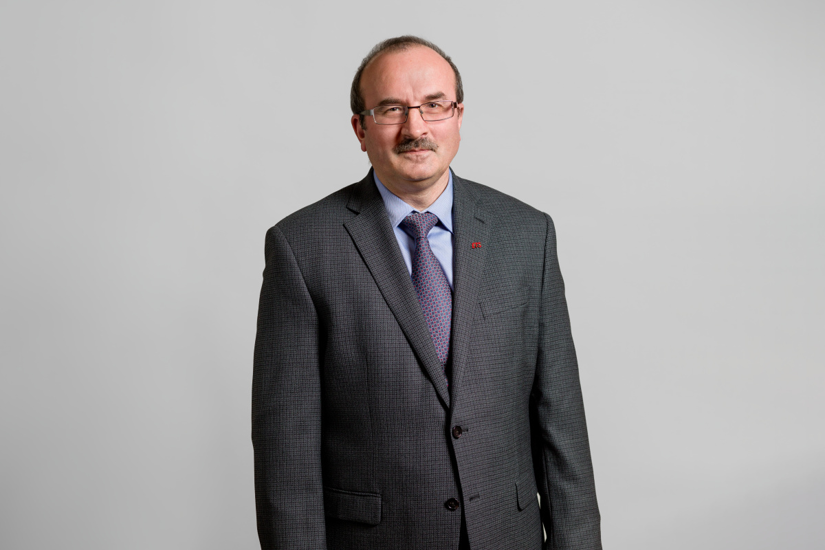 Professional faculty member in a suit, representing the university's commitment to superior technology education.
