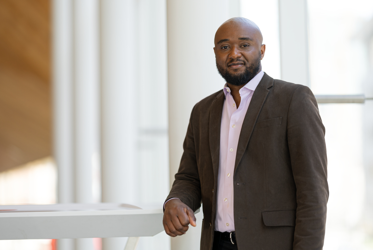 Confident professional at a tech university's modern facility.