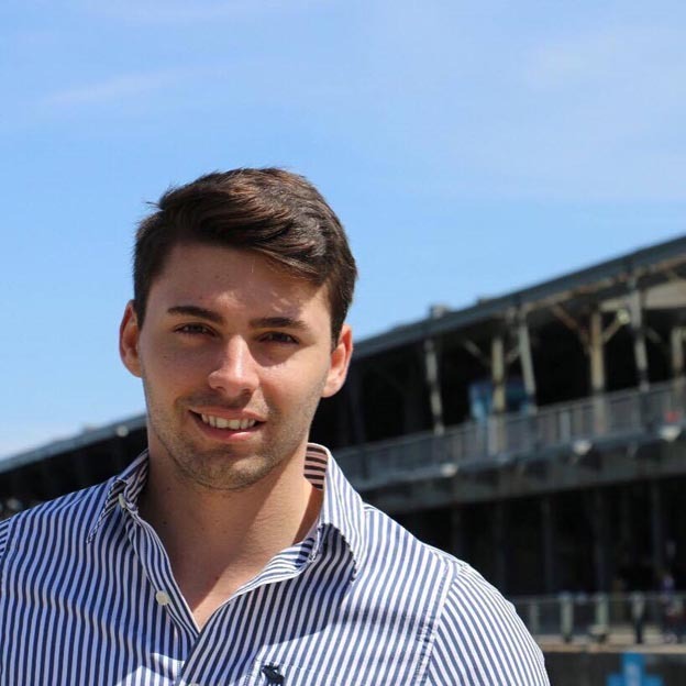 Young tech student in striped shirt, with construction in background, embodying progress and education.