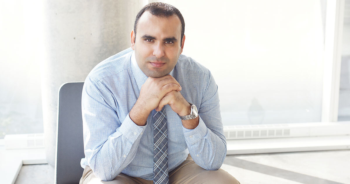 A professional in a blue shirt and tie reflects on technology advancements.