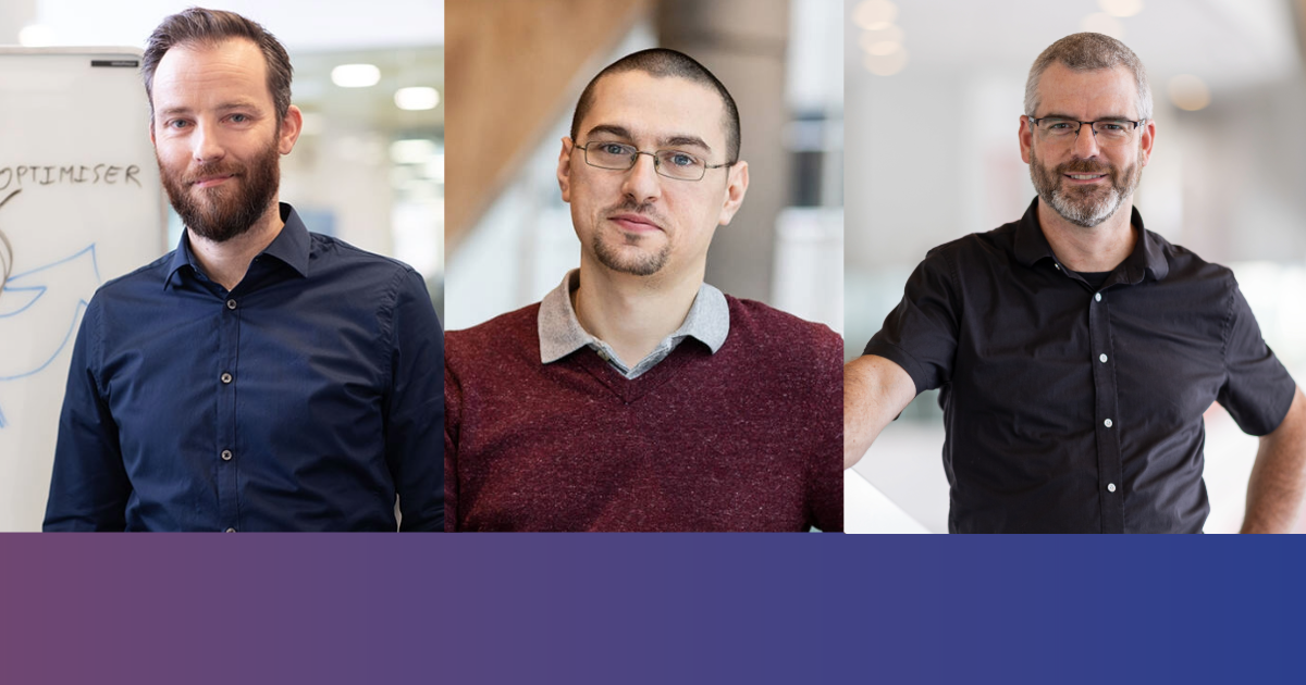 Three team members proudly standing in a modern environment, illustrating collaboration and innovation in technology.