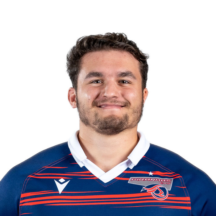 Étudiant en technologie, il porte un uniforme de rugby aux couleurs vives, affichant un sourire accueillant et déterminé.