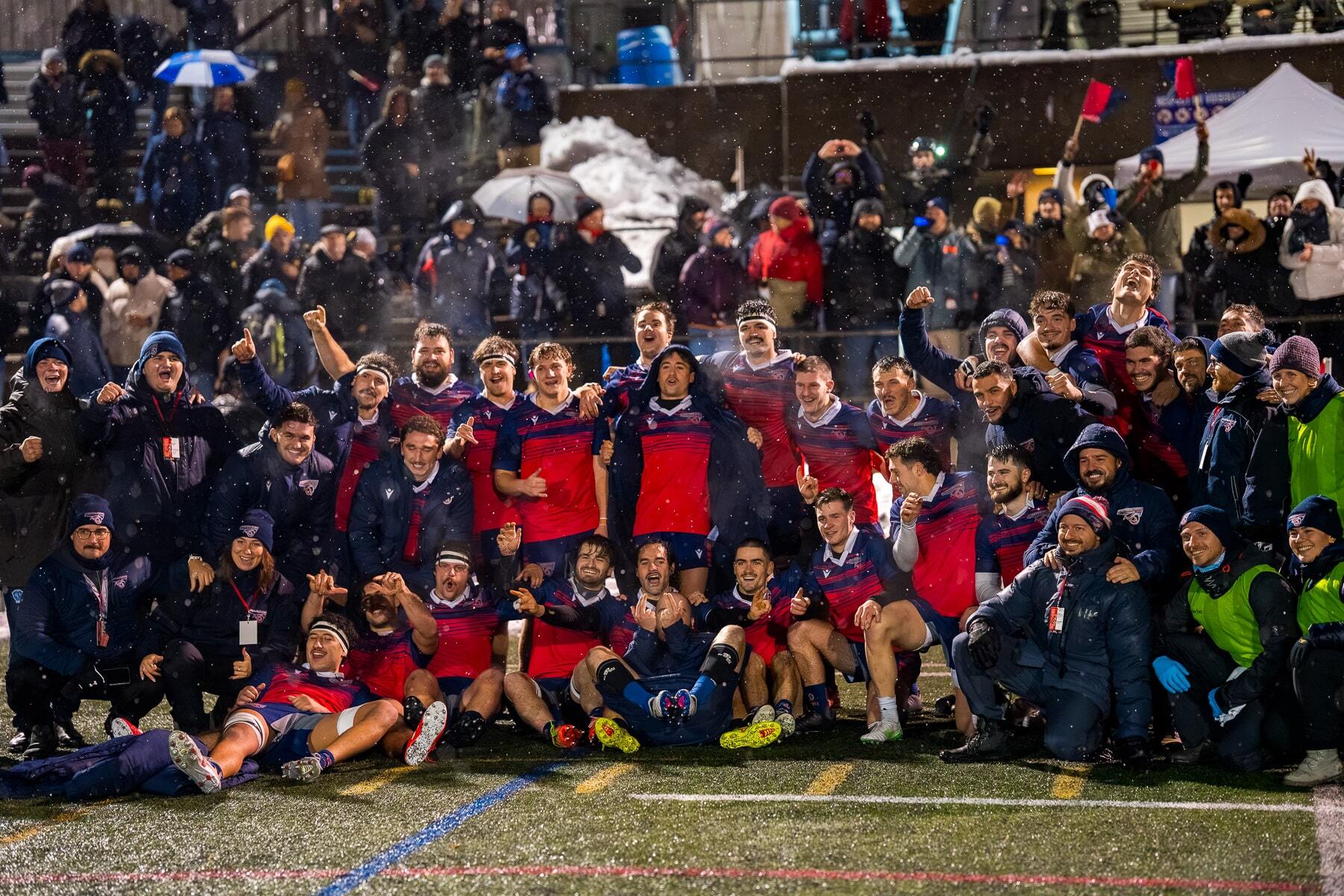 Une équipe de rugby célèbre sa victoire sous la neige, entourée de supporters enthousiastes. Ambiance festive et solidarité palpable.
