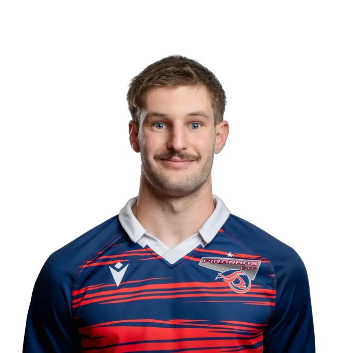 Étudiant en maillot sportif, souriant, fond neutre.