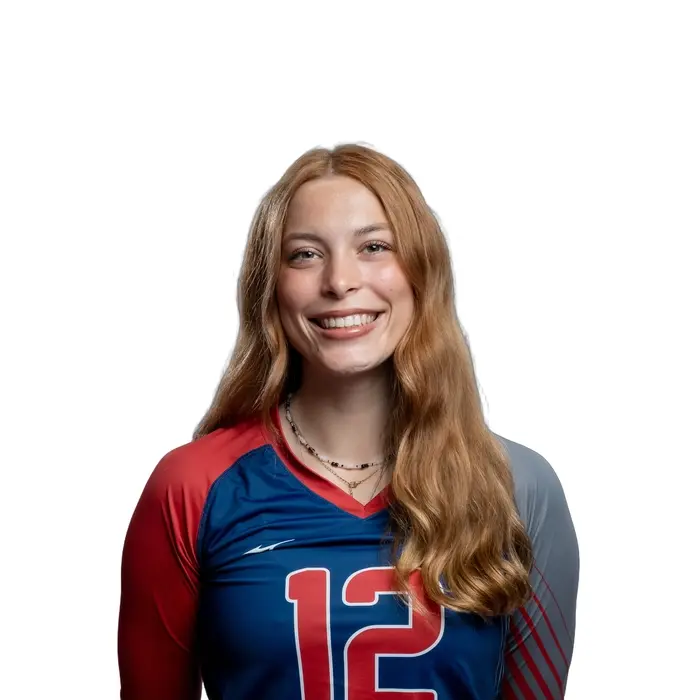 Athlète souriante en tenue de volley-ball, représentant fièrement son équipe avec passion et détermination.