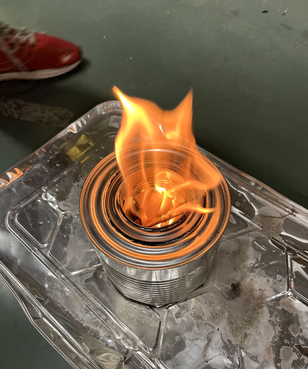 Flame rising from a metal low-tech oven.