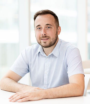 Professional with a friendly demeanor geared for success in a high-tech academic environment.