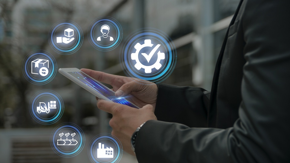 A professional managing various logistics and technology solutions through a tablet, showcasing digital innovation in industry.