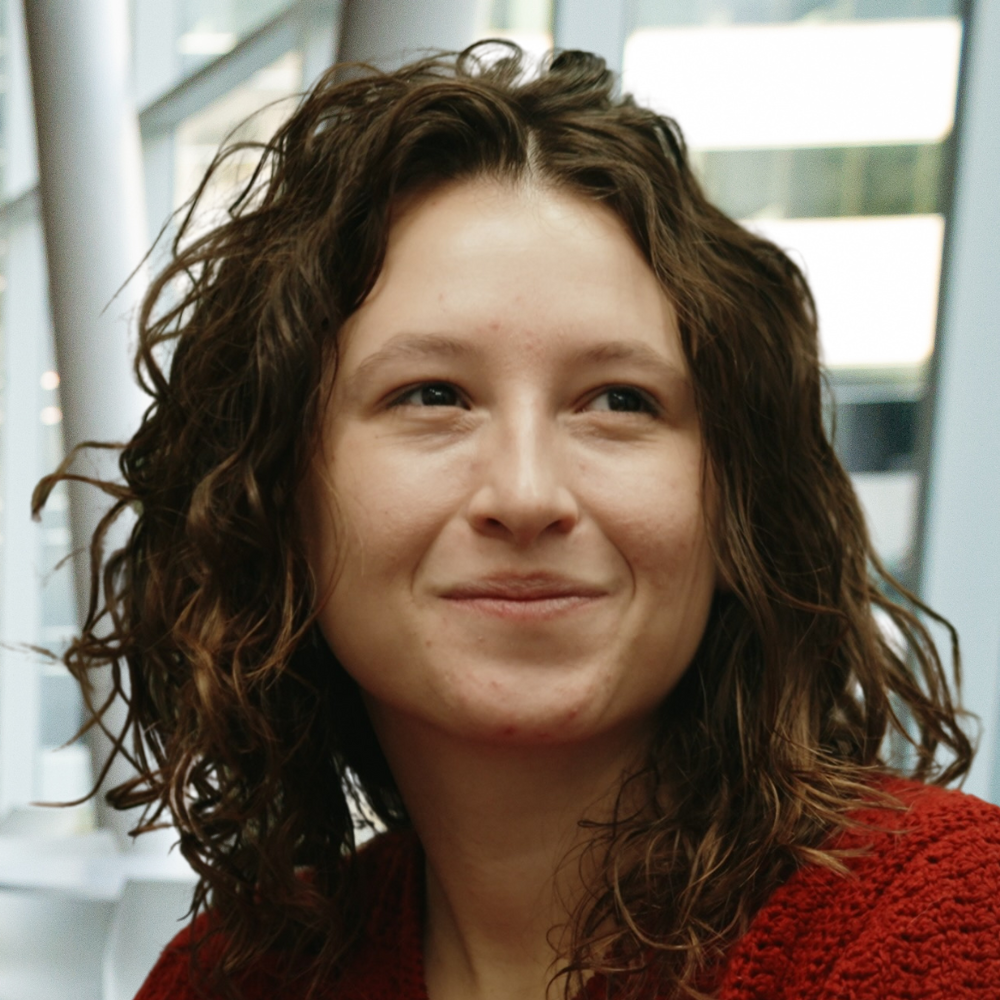 A student engaged in thoughtful conversation, radiating curiosity and enthusiasm in an innovative learning environment.