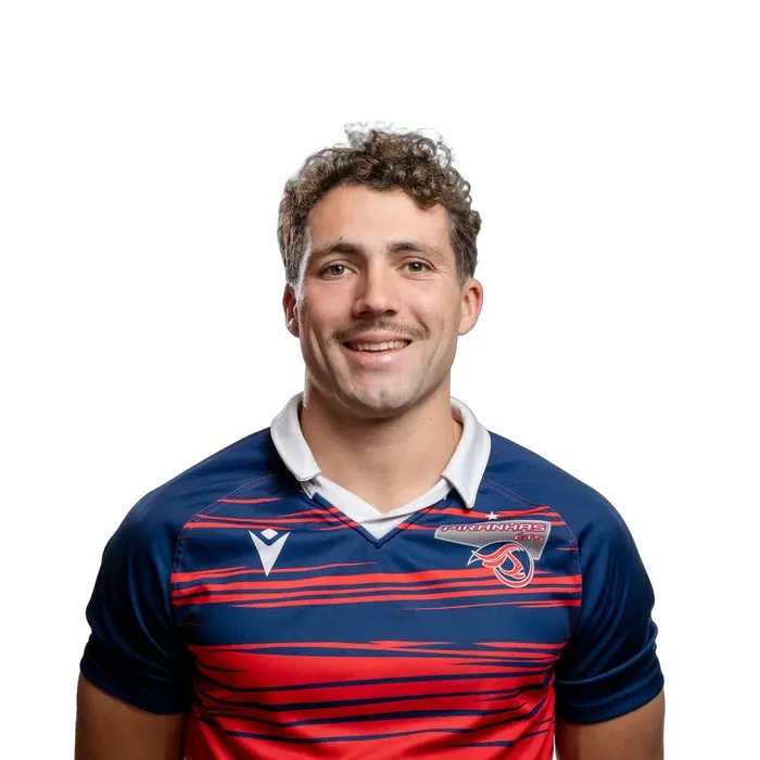 Étudiant en technologie, portant un maillot aux couleurs vibrantes, il affiche un sourire confiant et une détermination inspirante.