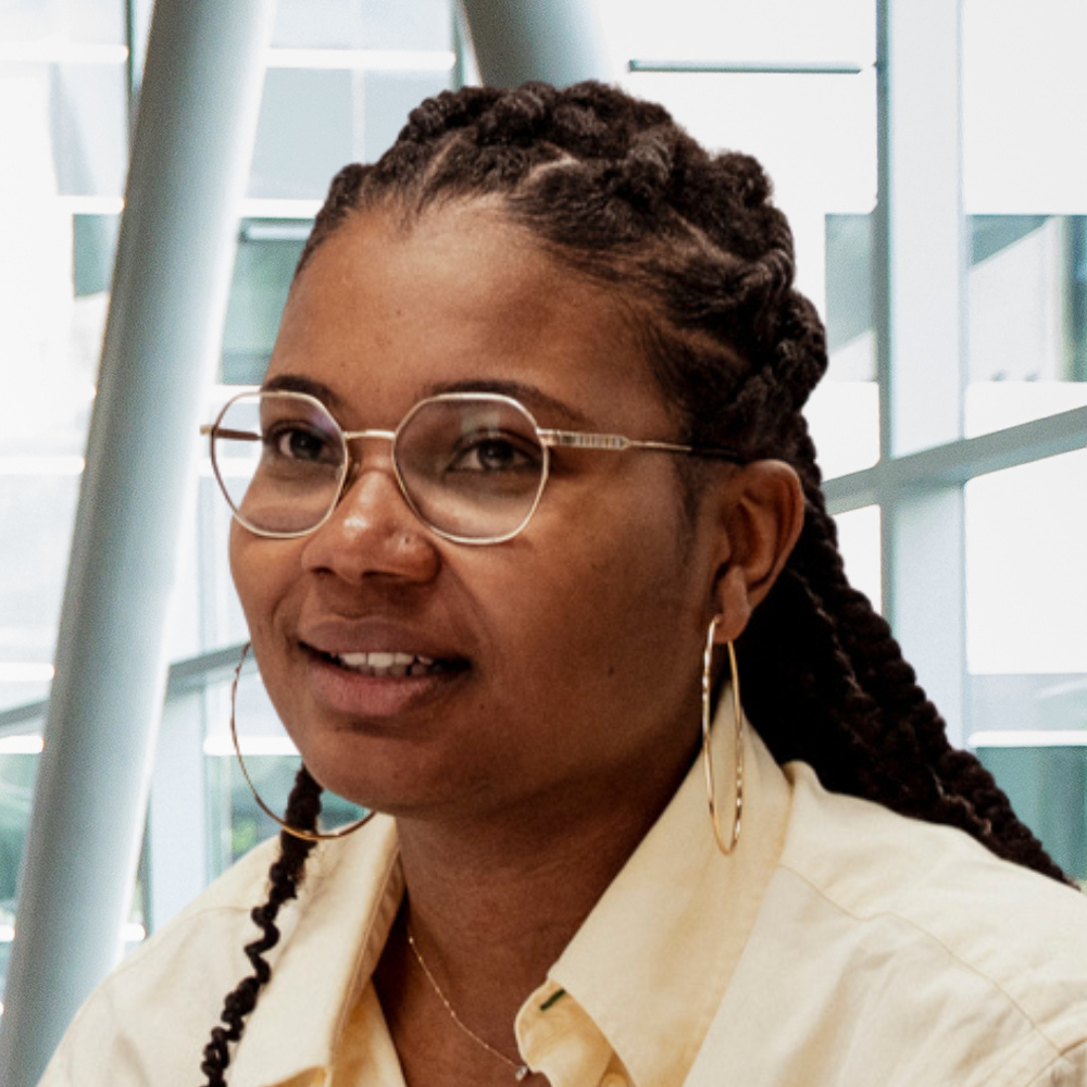 A student engages thoughtfully in a modern educational environment, showcasing enthusiasm for technology and learning.