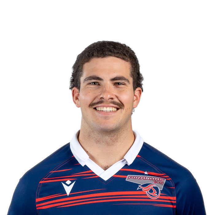 Étudiant souriant en tenue de sport universitaire, représentant fièrement son équipe.
