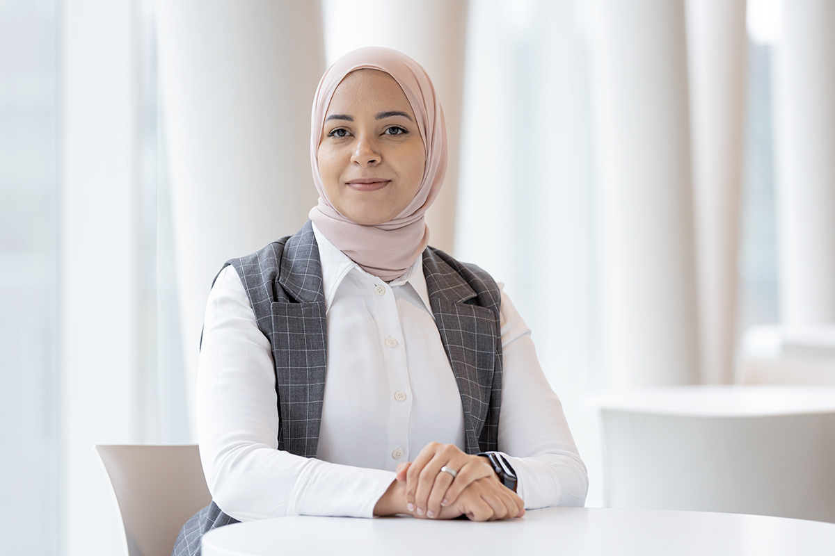 Higher education student, smiling and confident, dressed in a white shirt and a vest, ready to take on new challenges.
