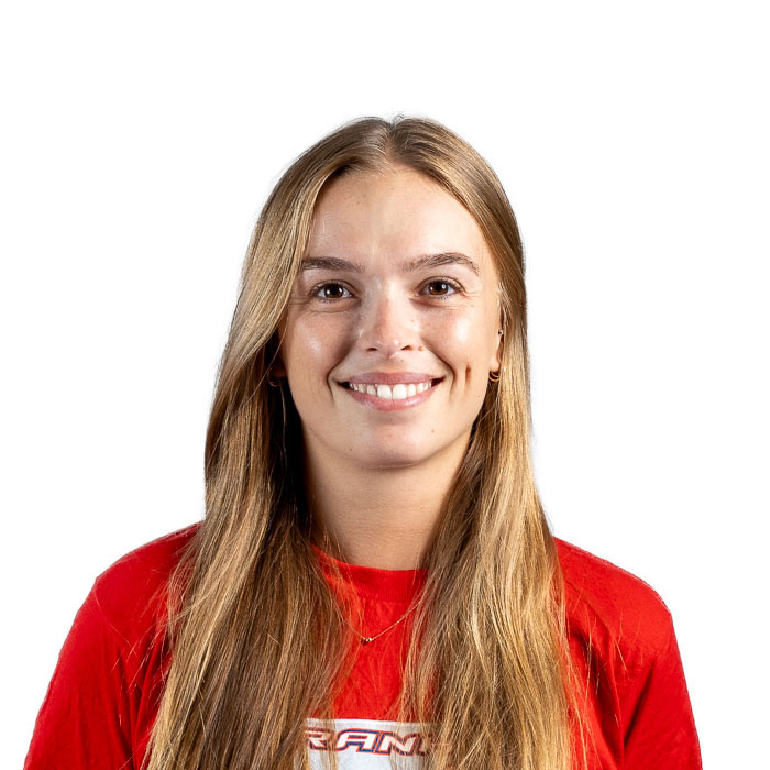 Étudiante enthousiaste en technologie, souriante, portant un t-shirt rouge. Elle incarne l'esprit dynamique de l'Université.