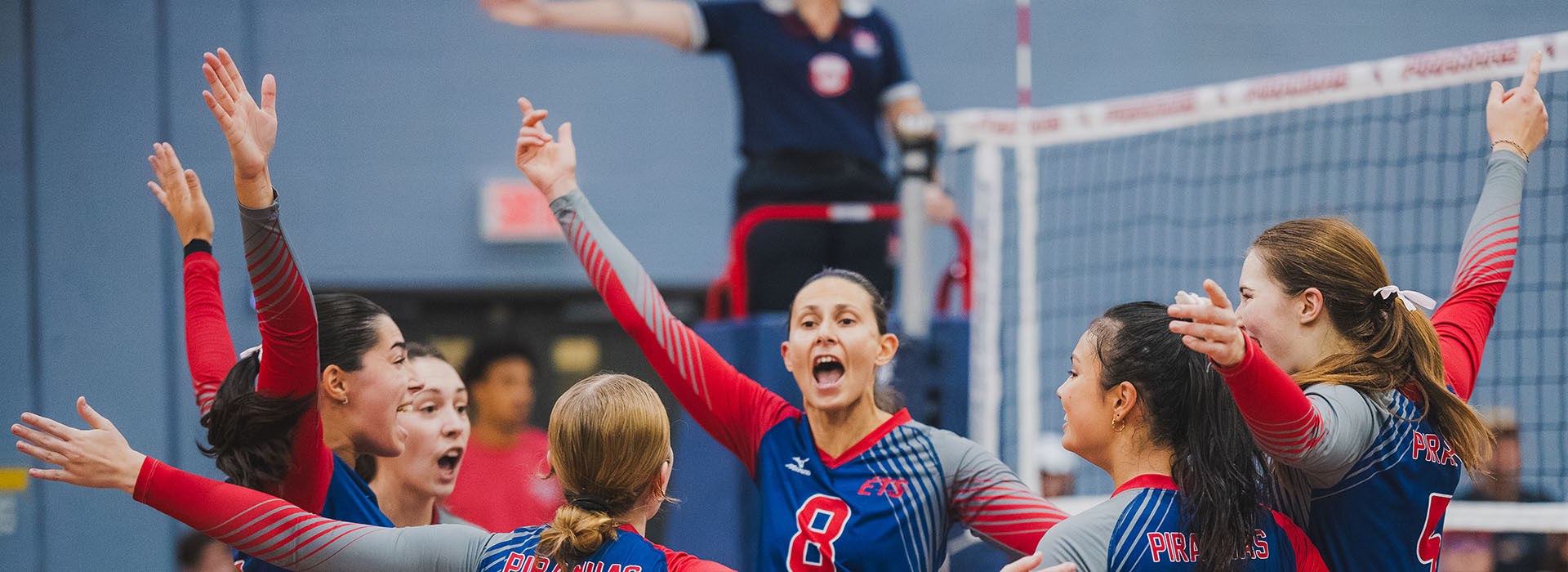 Volleyball team celebrating a victory with enthusiasm, gathered around their captain. Dynamic atmosphere and positive energy.