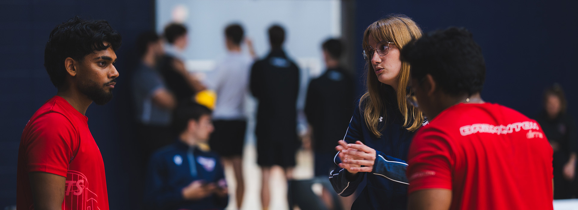 Students engage in discussion, showcasing collaboration and teamwork in a vibrant university environment.