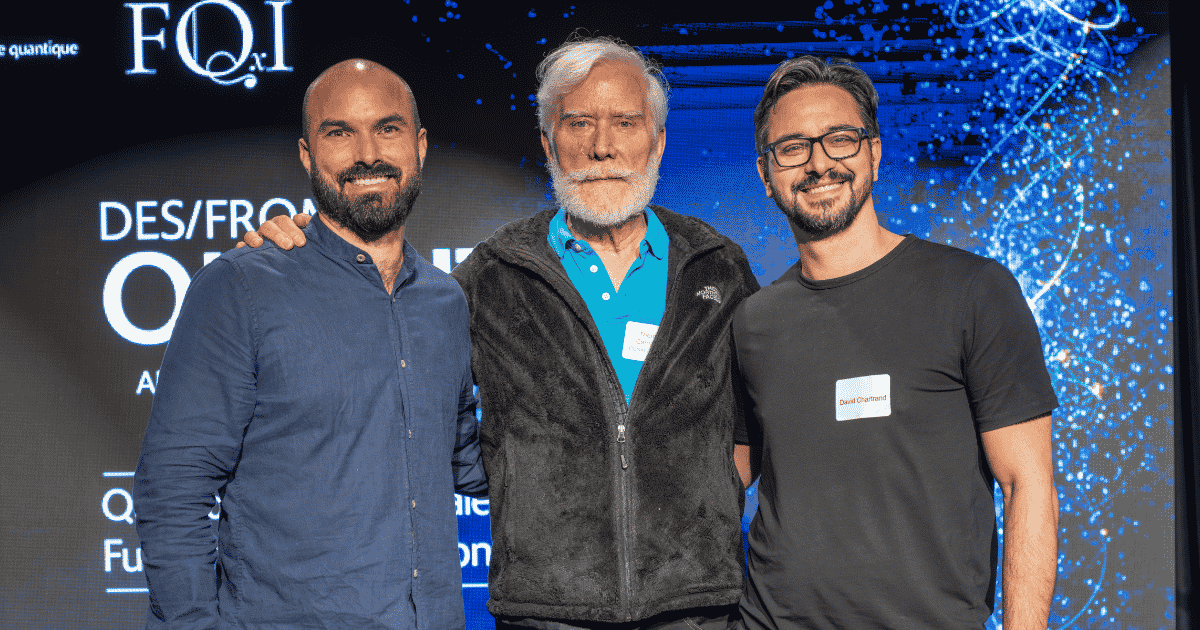 Three men pose together at a technology event, showcasing collaboration and innovation in advanced fields.