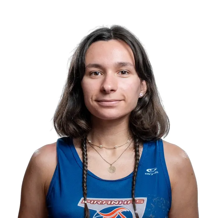 Étudiante souriante en tenue d'athlète avec logo Piranhas.