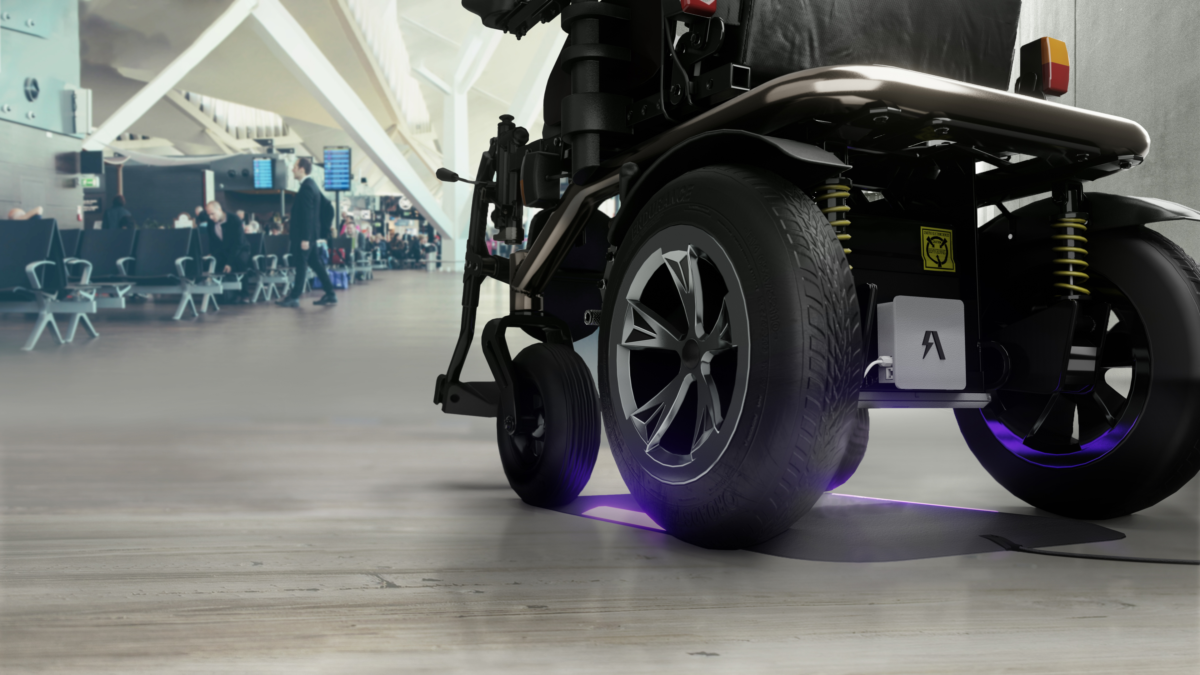 Modern wheelchair with sleek design and purple underglow in a university setting.